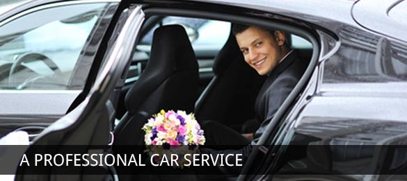 man smiling and holding flowers in a london taxi